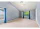 Expansive bedroom with vaulted ceiling, neutral carpeting, and large windows offering ample natural light at 5832 Sycamore Ridge Dr, Sugar Hill, GA 30518
