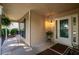 Inviting front porch with decorative hanging fern, a seating area, and sidelight windows at 5832 Sycamore Ridge Dr, Sugar Hill, GA 30518