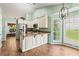 Spacious eat-in kitchen with stainless steel appliances, granite countertops, and a bay window at 5832 Sycamore Ridge Dr, Sugar Hill, GA 30518