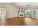 Spacious living room with a fireplace, wood flooring, and natural light from exterior access at 5832 Sycamore Ridge Dr, Sugar Hill, GA 30518