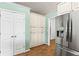 Convenient walk-in pantry with abundant shelving and storage space, adjacent to the stainless refrigerator at 5832 Sycamore Ridge Dr, Sugar Hill, GA 30518