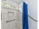 Walk-in shower featuring grab bars and a built-in bench at 5832 Sycamore Ridge Dr, Sugar Hill, GA 30518