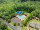Aerial view of community pool, tennis courts, clubhouse and lush surrounding greenery at 7535 Antique Barn Ave, Cumming, GA 30041