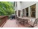 Relax on this spacious back deck perfect for outdoor dining and entertaining with lush backyard views at 7535 Antique Barn Ave, Cumming, GA 30041