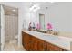 Bathroom with double sink vanity, wooden cabinets, and tiled floors at 7535 Antique Barn Ave, Cumming, GA 30041
