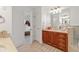 Elegant bathroom with double vanity, tile flooring, and a separate shower area, seamlessly connected to the main bedroom at 7535 Antique Barn Ave, Cumming, GA 30041