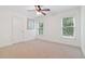 Empty bedroom features neutral walls and carpet, and two windows at 7535 Antique Barn Ave, Cumming, GA 30041
