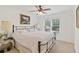Bedroom with neutral walls and carpet, large window, and decorative lamps at 7535 Antique Barn Ave, Cumming, GA 30041