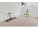 Bright bonus room with neutral carpet, a ceiling fan, and a window overlooking the property at 7535 Antique Barn Ave, Cumming, GA 30041