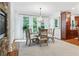 Bright dining room with a glass table, ornate chairs, hardwood floors, and a stylish chandelier at 7535 Antique Barn Ave, Cumming, GA 30041