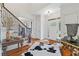 Bright foyer with hardwood floors, a staircase, and decor providing a warm and inviting entry at 7535 Antique Barn Ave, Cumming, GA 30041