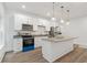 Bright kitchen with granite counters, stainless appliances, and kitchen island at 7535 Antique Barn Ave, Cumming, GA 30041