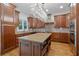 Spacious kitchen boasting custom wood cabinets, granite countertops, and a large central island at 7535 Antique Barn Ave, Cumming, GA 30041