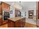 Elegant kitchen with a large island, stainless steel appliances, and seamless flow to the living area at 7535 Antique Barn Ave, Cumming, GA 30041