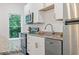 Kitchen features stainless steel appliances and white cabinetry at 7535 Antique Barn Ave, Cumming, GA 30041