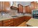 Well-appointed kitchen showcasing custom cabinetry, tile backsplash, and modern stainless steel appliances at 7535 Antique Barn Ave, Cumming, GA 30041