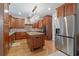 Gourmet kitchen with cherry cabinets, a center island, granite countertops, and stainless steel appliances at 7535 Antique Barn Ave, Cumming, GA 30041