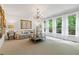 Bright living room with carpet, chandelier, large windows, and tasteful decor, offering a comfortable living space at 7535 Antique Barn Ave, Cumming, GA 30041