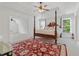 Luxurious main bedroom with a tray ceiling, four-poster bed, and an abundance of natural light at 7535 Antique Barn Ave, Cumming, GA 30041