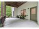 Spacious outdoor patio area featuring potted plants, a window, and seating offering views of the surrounding lush greenery at 7535 Antique Barn Ave, Cumming, GA 30041