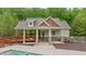Community pool house featuring stone accents, covered porch, and easy access via ramp at 7535 Antique Barn Ave, Cumming, GA 30041