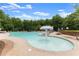 Community swimming pool with zero entry, sun shade, chaise lounges and plenty of seating at 7535 Antique Barn Ave, Cumming, GA 30041