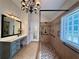 Bathroom features a glass shower with seating, a vanity, and a large mirror at 112 Countryside Ct, Woodstock, GA 30189