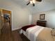 Comfortable bedroom features ceiling fan, hardwood floors, and ensuite access at 112 Countryside Ct, Woodstock, GA 30189