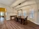 Bright dining room with plantation shutters, wood-look floors, and a modern chandelier at 112 Countryside Ct, Woodstock, GA 30189