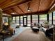 Inviting sunroom with wood ceiling, fan, comfortable seating, and views of the outdoors at 112 Countryside Ct, Woodstock, GA 30189