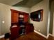 Dedicated workstation with storage cabinets, a computer, and a wall-mounted TV at 112 Countryside Ct, Woodstock, GA 30189