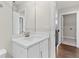 Bathroom features a white vanity, large mirror, and is conveniently located near the laundry area at 4020 Townsend Ln, Atlanta, GA 30346