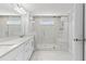 Modern bathroom featuring a large glass-enclosed shower with a bench, double vanity with marble countertops, and tile floors at 4020 Townsend Ln, Atlanta, GA 30346