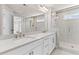 A modern bathroom featuring a glass-enclosed shower, double vanity with marble countertops, and tile floors at 4020 Townsend Ln, Atlanta, GA 30346
