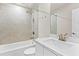 Bathroom featuring a shower-tub combo with beige tile and a white vanity with a large mirror at 4020 Townsend Ln, Atlanta, GA 30346