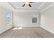 Spacious bedroom with tray ceiling, carpet, and large windows offering ample natural light at 4020 Townsend Ln, Atlanta, GA 30346