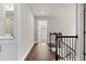 Well-lit hallway with hardwood floors connecting various rooms, featuring white trim and neutral walls at 4020 Townsend Ln, Atlanta, GA 30346