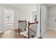 Open hallway with hardwood floors, a staircase, and access to the laundry and bedrooms at 4020 Townsend Ln, Atlanta, GA 30346