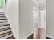 Hallway with wooden staircase, hardwood floors, and access to the bedroom and bathroom at 4020 Townsend Ln, Atlanta, GA 30346