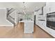 Modern kitchen includes stainless appliances, white cabinetry and countertops, with a large island and eat-in dining area at 4020 Townsend Ln, Atlanta, GA 30346