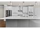 Bright kitchen boasts stainless appliances, a stylish island, and a view of the cabinetry and subway tile backsplash at 4020 Townsend Ln, Atlanta, GA 30346