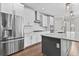 The kitchen features stainless steel appliances, white cabinetry, and a central island for food preparation and dining at 4020 Townsend Ln, Atlanta, GA 30346