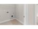 Clean laundry room with tile flooring, hookups, and wire shelving, perfect for storage at 4020 Townsend Ln, Atlanta, GA 30346