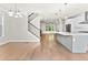 Open-concept living space with hardwood floors, modern light fixture, and easy access to the kitchen and staircase at 4020 Townsend Ln, Atlanta, GA 30346