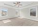 Spacious main bedroom with tray ceiling, ceiling fan, carpeted floors, and multiple windows for natural light at 4020 Townsend Ln, Atlanta, GA 30346