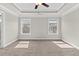 Spacious main bedroom with tray ceiling, ceiling fan, carpeted floors, and multiple windows for natural light at 4020 Townsend Ln, Atlanta, GA 30346