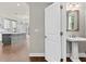 Conveniently-located powder room with pedestal sink and nearby access to an open layout of kitchen and living space at 4020 Townsend Ln, Atlanta, GA 30346
