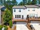 Rear exterior of a home featuring a spacious deck and a two-car garage at 4020 Townsend Ln, Atlanta, GA 30346