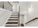 Staircase with stained hardwood treads, white risers, and custom iron railing at 4020 Townsend Ln, Atlanta, GA 30346