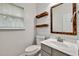 Bathroom featuring shiplap walls, wood accents, and a modern vanity with a sink at 6625 Eagle Pt, Suwanee, GA 30024